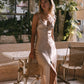 Woman in a beige slip dress standing in an outdoor 