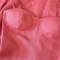 Close up of coral linen corset dress showing structured cups and natural linen texture
