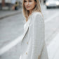 Back view of a beige linen blazer showing its straight relaxed silhouette