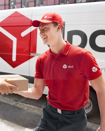 DPD delivery person handing over a package in front of a DPD van.