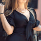 Woman wearing a black dress with a blurred background