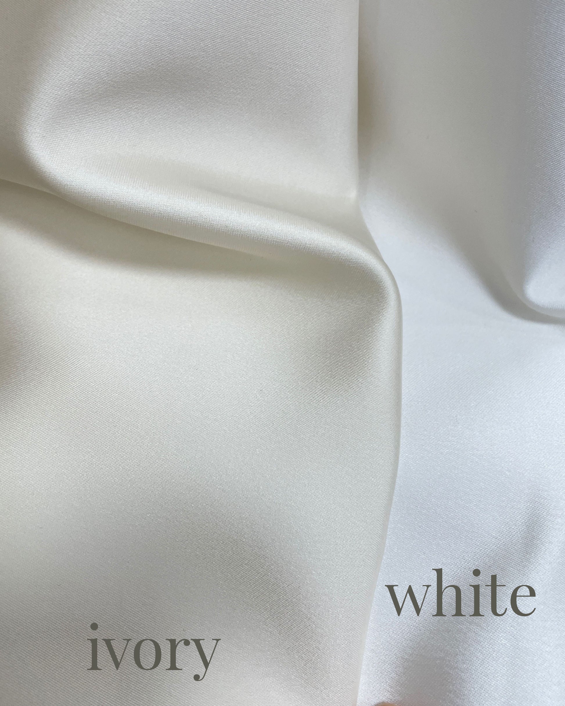 A close-up of draped fabric in two colorways labeled 'ivory' and 'white', showing a smooth silk texture with soft folds.