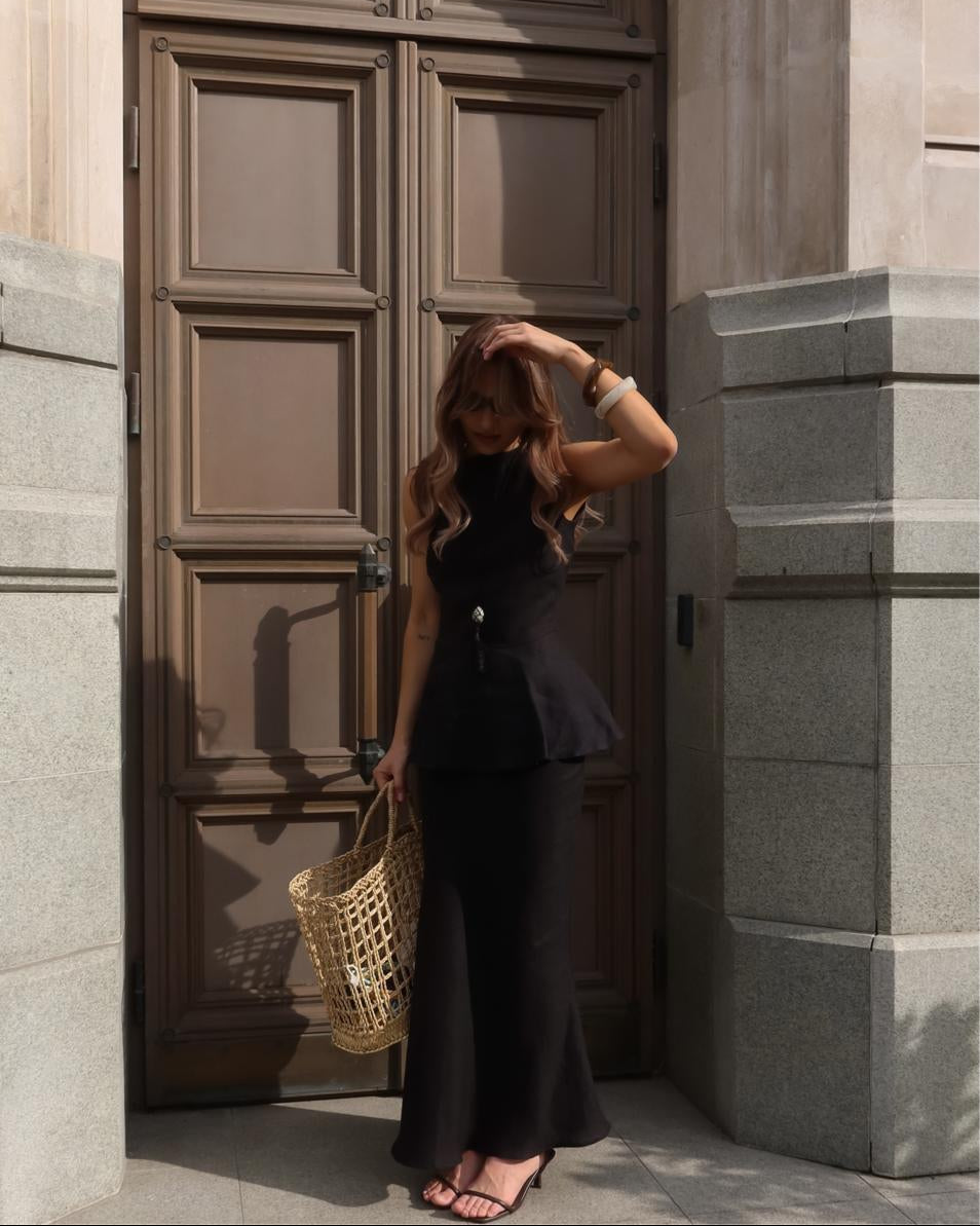 Minimal black linen peplum top with structured silhouette
