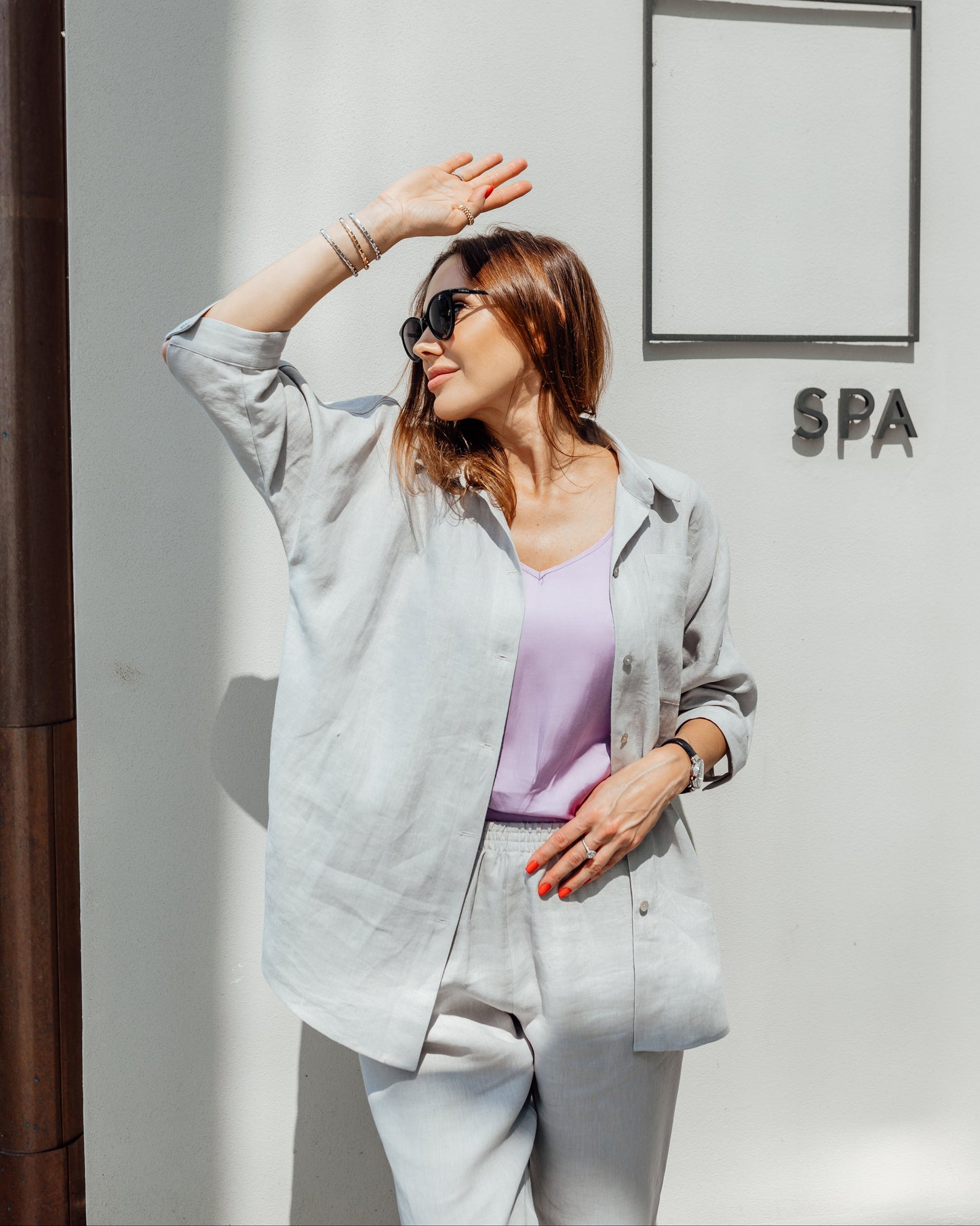 Woman styling a grey linen co-ord set with relaxed silhouette