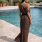 Back view of a chocolate brown one shoulder linen dress with asymmetric draped back and back slit.