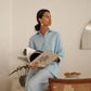 Women in sky blue linen shirt and trousers