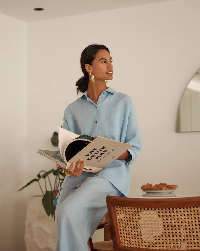 Women in sky blue linen shirt and trousers