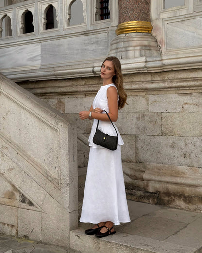 White bias cut linen maxi skirt with flowing silhouette