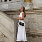 White sleeveless linen peplum top with matching maxi skirt