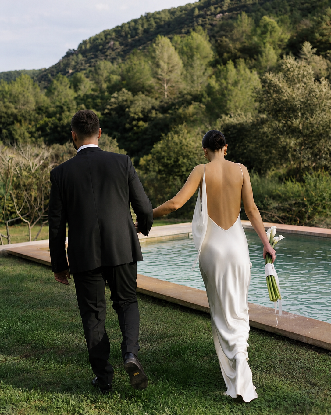 Full length back view of an ivory backless silk maxi dress.
