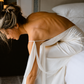 Side view of an ivory silk maxi dress with a dramatic open back.