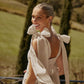Beige linen midi dress with open back and adjustable shoulder bows