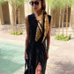 Black linen wrap maxi dress worn beside a swimming pool.