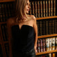 Woman wearing the ECLAT velvet corset, showing the fitted boned bodice and distinctive notched neckline that creates a softly sculpted bust.