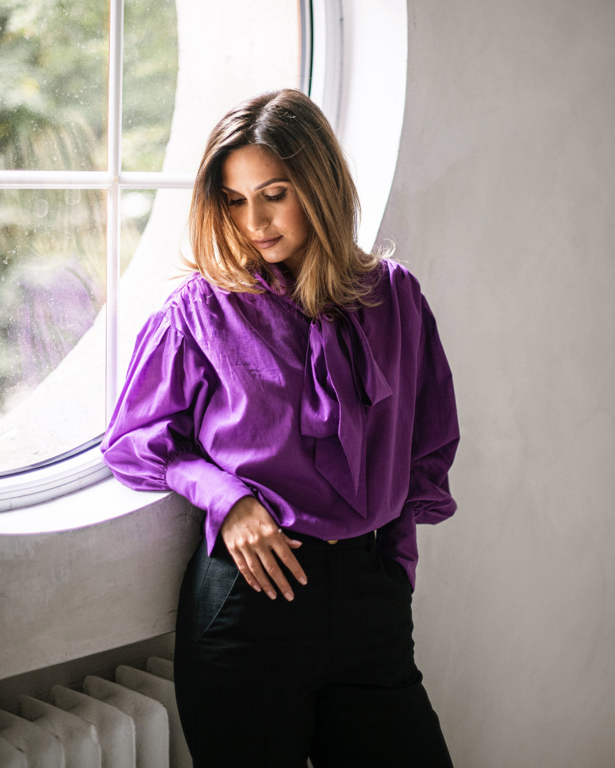 Purple tie-neck blouse with voluminous sleeves and extra-long structured French cuffs