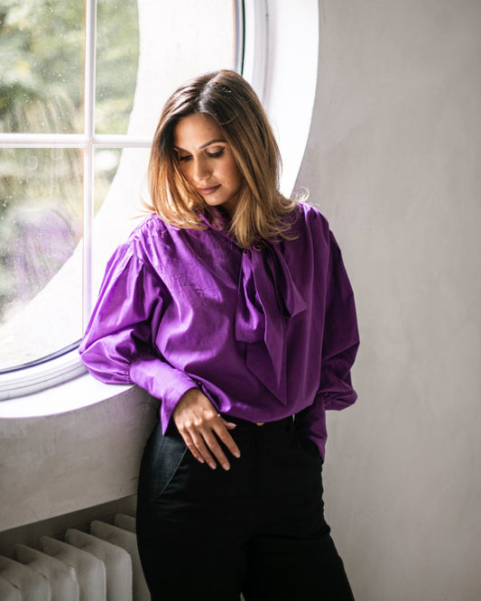 Purple tie-neck blouse with voluminous sleeves and extra-long structured French cuffs