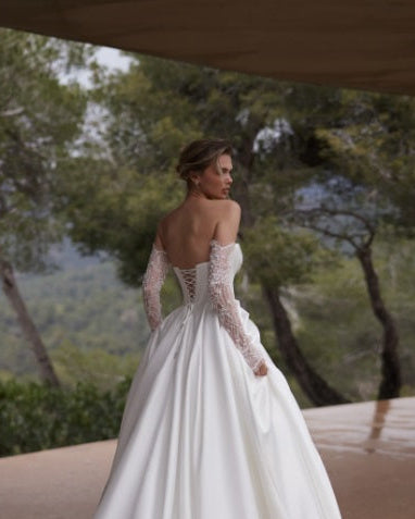 A bride in a white satin corset back 