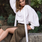 White ascot blouse with long loose neck ties, voluminous sleeves and an extended structured cuff.