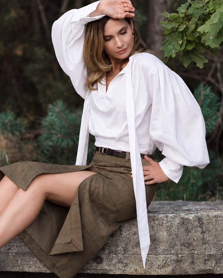 White ascot blouse with long loose neck ties, voluminous sleeves and an extended structured cuff.