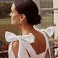 Close up of white linen shoulder bows and open back detail