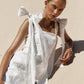 White linen midi dress with adjustable shoulder bows and square neckline