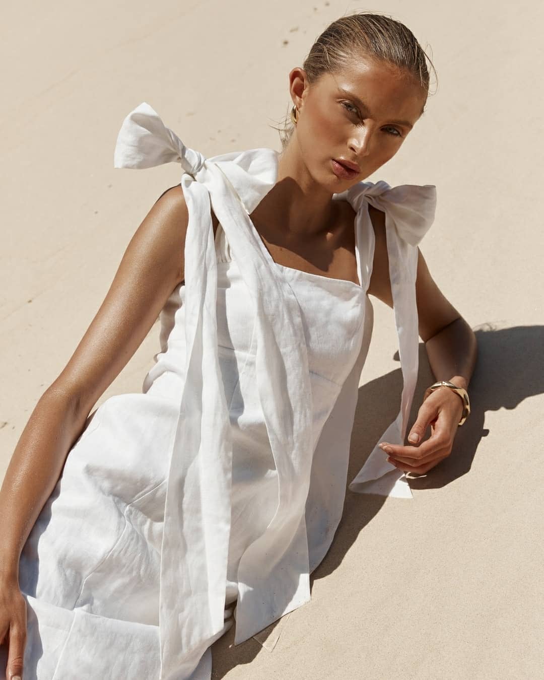 White linen midi dress with adjustable shoulder bows and square neckline