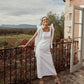 Full length white linen midi dress with square neckline and shoulder bows