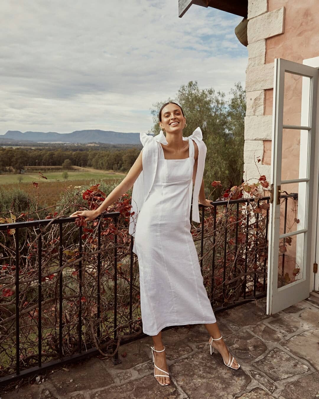 Full length white linen midi dress with square neckline and shoulder bows