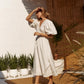 White linen wrap midi dress with puff sleeves side view